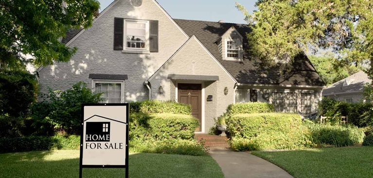 Home with for sale sign